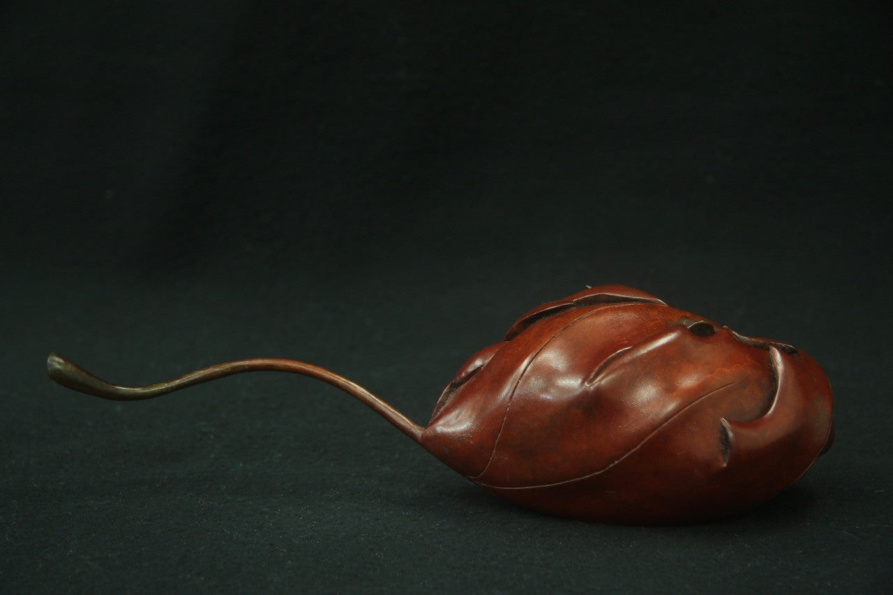 Bronze sculpture wren in maple leaf
